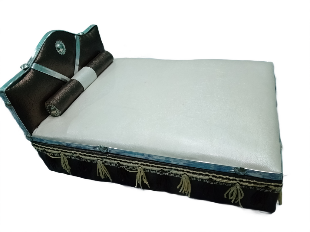 White cushion with black and turquoise trim on a white background